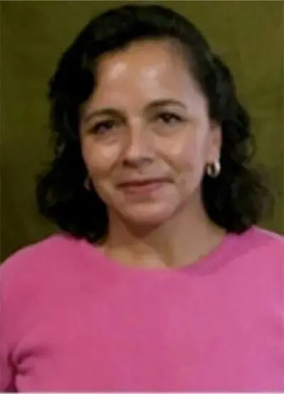 A woman in pink shirt and black hair.