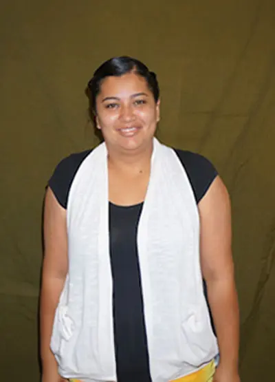 A woman wearing a white scarf and black shirt.