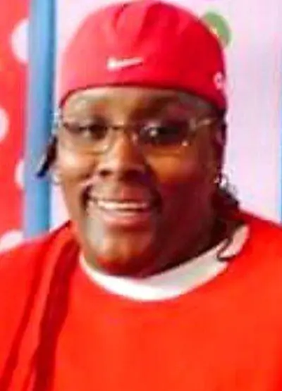 A person wearing glasses and a red hat.