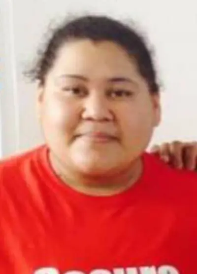 A woman in red shirt posing for the camera.