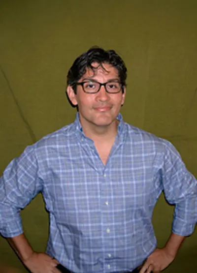 A man in glasses and a blue shirt