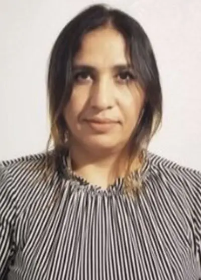 A woman with long hair wearing a striped shirt.